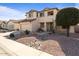 Well-maintained home with desert landscaping, a three-car garage, and a peaceful residential street at 18017 W Desert Ln, Surprise, AZ 85388