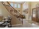 The home's entryway features tile flooring, a staircase, and a front door with glass accents at 18017 W Desert Ln, Surprise, AZ 85388