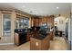 Spacious kitchen boasting wood cabinetry, black appliances, and a convenient center island at 18017 W Desert Ln, Surprise, AZ 85388