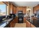 Attractive kitchen featuring wood cabinets, black appliances, and a functional center island at 18017 W Desert Ln, Surprise, AZ 85388