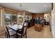 Inviting kitchen and dining area with dark wood cabinets, tile floors, and natural light at 18017 W Desert Ln, Surprise, AZ 85388