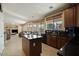 Open-concept kitchen with center island seamlessly connects to the living and dining spaces at 18017 W Desert Ln, Surprise, AZ 85388