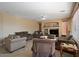 Bright living room boasts tile floors, large windows, and a cozy fireplace with built-in shelving at 18017 W Desert Ln, Surprise, AZ 85388