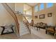 The living area features soaring ceilings, a winding staircase, and lots of natural light from clerestory windows at 18017 W Desert Ln, Surprise, AZ 85388