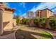 Well-maintained backyard with green grass, mature trees, shrubs and a walking path at 21134 W Sunrise Ln, Buckeye, AZ 85396