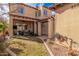 Expansive backyard featuring a covered patio, lush green grass, hardscape, and desert landscaping at 21134 W Sunrise Ln, Buckeye, AZ 85396