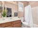 Clean bathroom featuring a vanity with wood cabinets and a shower with a white shower curtain at 21134 W Sunrise Ln, Buckeye, AZ 85396