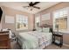 Inviting bedroom with a wrought iron bed frame, and light colored walls and carpet at 21134 W Sunrise Ln, Buckeye, AZ 85396