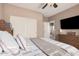 Comfortable bedroom featuring plush bedding, a ceiling fan, and ample storage at 21134 W Sunrise Ln, Buckeye, AZ 85396