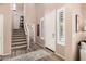 Grand entryway featuring a staircase, high ceilings, and white doors with abundant natural light at 21134 W Sunrise Ln, Buckeye, AZ 85396