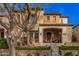 Charming two-story home with a welcoming front porch, landscaping, and terra cotta roof tiles at 21134 W Sunrise Ln, Buckeye, AZ 85396