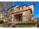 Charming two-story home with a welcoming front porch, landscaping, and terra cotta roof tiles at 21134 W Sunrise Ln, Buckeye, AZ 85396
