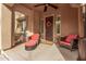 Inviting front porch featuring comfortable seating, a ceiling fan, and a decorative wreath on the front door at 21134 W Sunrise Ln, Buckeye, AZ 85396
