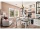 Bright office featuring built-in shelving, hardwood floors, natural light, and a modern chandelier at 21134 W Sunrise Ln, Buckeye, AZ 85396