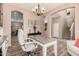 Bright office featuring built-in shelving, hardwood floors, natural light, and a modern chandelier at 21134 W Sunrise Ln, Buckeye, AZ 85396