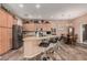 Well-designed kitchen featuring an island with seating, stainless steel appliances, and wooden cabinets at 21134 W Sunrise Ln, Buckeye, AZ 85396