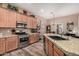 Spacious kitchen featuring granite countertops, stainless steel appliances, and wooden cabinetry at 21134 W Sunrise Ln, Buckeye, AZ 85396