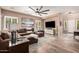Bright living room with a large sectional sofa, modern ceiling fan, and a white media console at 21134 W Sunrise Ln, Buckeye, AZ 85396