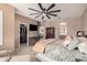 Main bedroom features a large ceiling fan, TV, closet, and seating area at 21134 W Sunrise Ln, Buckeye, AZ 85396