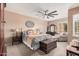 Spacious main bedroom with a ceiling fan, furnishings, and a decorative wall hanging at 21134 W Sunrise Ln, Buckeye, AZ 85396