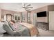 Comfortable main bedroom with large ceiling fan, lots of light, and dark furnishings at 21134 W Sunrise Ln, Buckeye, AZ 85396