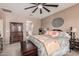 This main bedroom features a ceiling fan, decorative wall hanging, and nice furnishings at 21134 W Sunrise Ln, Buckeye, AZ 85396