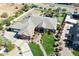 Aerial view of a red brick home with a lush lawn, mature landscaping, driveway and beautiful community at 2222 N Val Vista Dr # 2, Mesa, AZ 85213