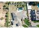 Aerial view of a home with a pool, patio area, verdant yard, and mature trees in a Gathering-friendly neighborhood at 2222 N Val Vista Dr # 2, Mesa, AZ 85213