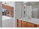Bathroom with single sink, cabinets, large mirror, and view to patio at 2222 N Val Vista Dr # 2, Mesa, AZ 85213
