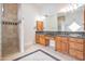 Bathroom featuring double sinks, granite countertop, walk-in shower and tile floors at 2222 N Val Vista Dr # 2, Mesa, AZ 85213