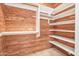 Walk-in closet featuring cedar wood paneling, built-in shelving, and ample storage space at 2222 N Val Vista Dr # 2, Mesa, AZ 85213