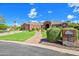 Expansive red brick home featuring manicured landscaping, lush green lawn, and a welcoming brick pathway at 2222 N Val Vista Dr # 2, Mesa, AZ 85213