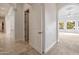 Hallway featuring tile flooring, leading to rooms with carpet and large windows at 2222 N Val Vista Dr # 2, Mesa, AZ 85213