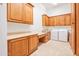 Well-appointed laundry room with ample cabinetry, countertop space and modern washer and dryer units at 2222 N Val Vista Dr # 2, Mesa, AZ 85213