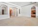Spacious living room with plush carpet, white walls, and arched doorways for an open feel at 2222 N Val Vista Dr # 2, Mesa, AZ 85213