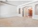 Open-concept living room with plush carpet, white walls, and arched doorways for an airy feel at 2222 N Val Vista Dr # 2, Mesa, AZ 85213