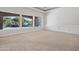Bright living room with neutral carpet, white walls, and backyard views of the water feature at 2222 N Val Vista Dr # 2, Mesa, AZ 85213