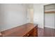 Office space with hardwood floors, a dark wood desk, and closet space for storage at 2222 N Val Vista Dr # 2, Mesa, AZ 85213