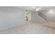 Open living room with tiled floors and staircase at 225 N Standage St # 78, Mesa, AZ 85201