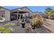 Backyard patio with a covered seating area and various plants at 23818 N High Dunes Dr, Florence, AZ 85132