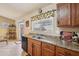 Kitchen features oak cabinets, double sink, and tile countertops at 25746 W Hess Ave, Buckeye, AZ 85326