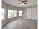Sun-filled bedroom with large windows, wood-look flooring, and spacious closet at 358 N 82Nd Way, Mesa, AZ 85207