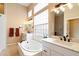 Bathroom with double vanity, soaking tub, and glass block window at 4163 N Morning Dove Cir, Mesa, AZ 85207