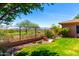 Beautiful backyard with manicured lawn and views of the lush green landscape and golf course at 42017 N Crooked Stick Rd, Anthem, AZ 85086