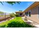Expansive backyard with green grass, a garden, and views of the desert landscaping at 42017 N Crooked Stick Rd, Anthem, AZ 85086