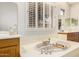 Relaxing soaking tub setting by shuttered windows in a bright ensuite bathroom at 42017 N Crooked Stick Rd, Anthem, AZ 85086