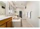 Ensuite bathroom featuring large soaking tub, vanity, and shuttered window at 42017 N Crooked Stick Rd, Anthem, AZ 85086