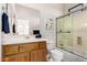 Neutral bathroom featuring a shower-tub combo and wooden cabinets at 42017 N Crooked Stick Rd, Anthem, AZ 85086