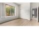 Well-lit bedroom with wood floors, a window with shutters, and a closet with sliding doors at 42017 N Crooked Stick Rd, Anthem, AZ 85086