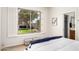 Bright bedroom with view of backyard, shuttered window, and wood laminate flooring at 42017 N Crooked Stick Rd, Anthem, AZ 85086